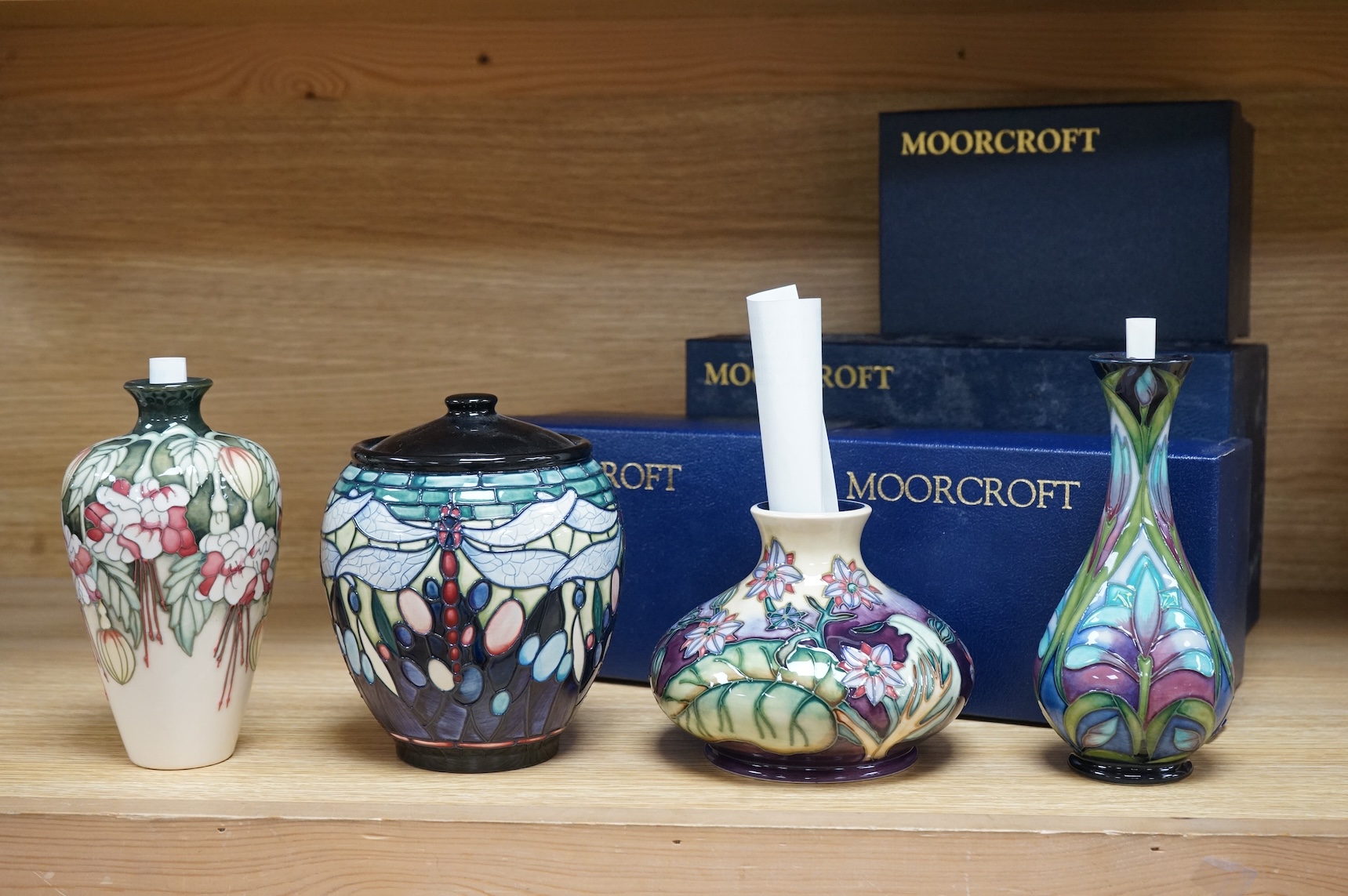 Four Moorcroft vases: Favrile Jar, Kerry vase, Cleopatra vase and a Borage vase. All boxed, tallest 17cm
